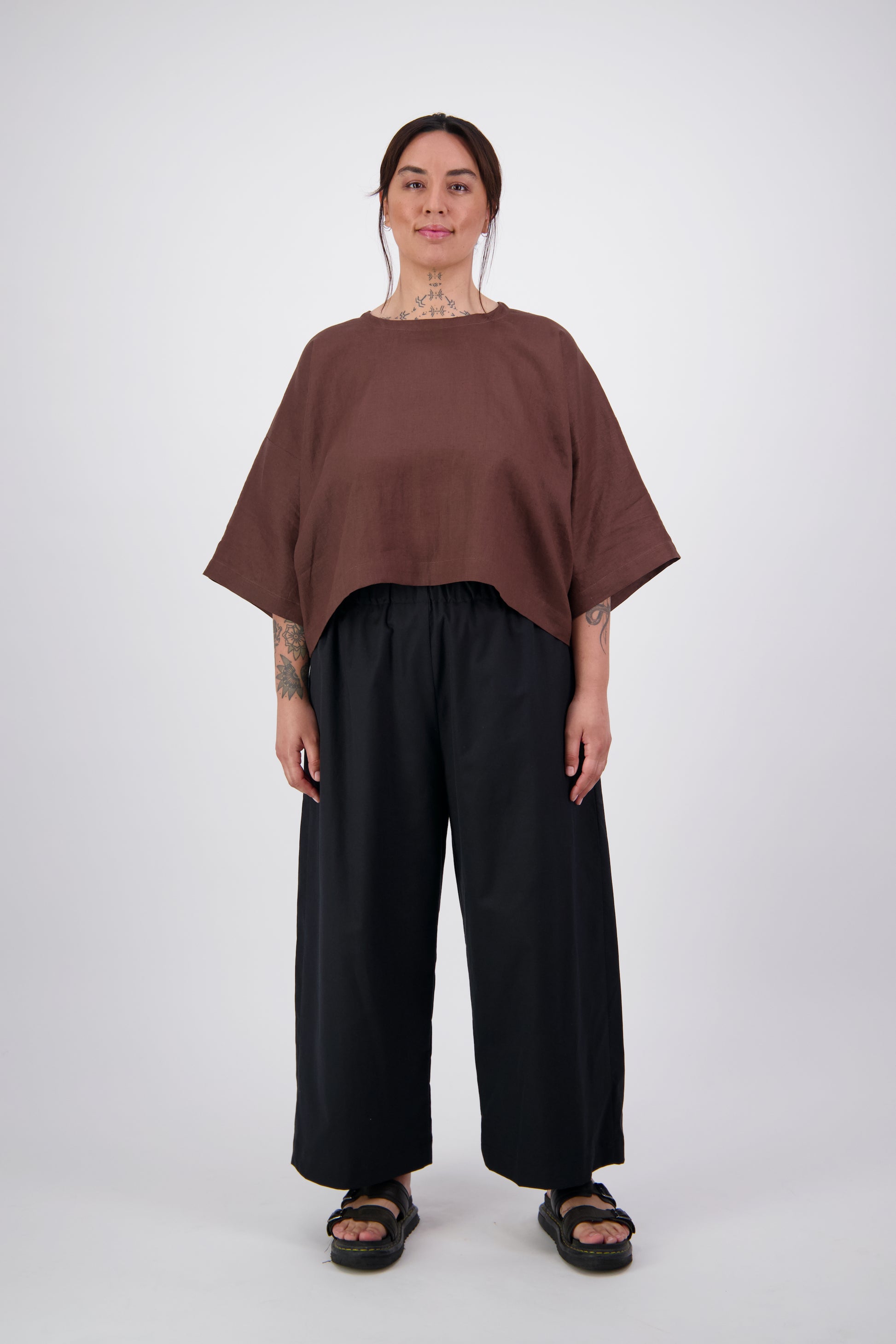 Arlena wearing black twill pants with a brown linen crop tee top
