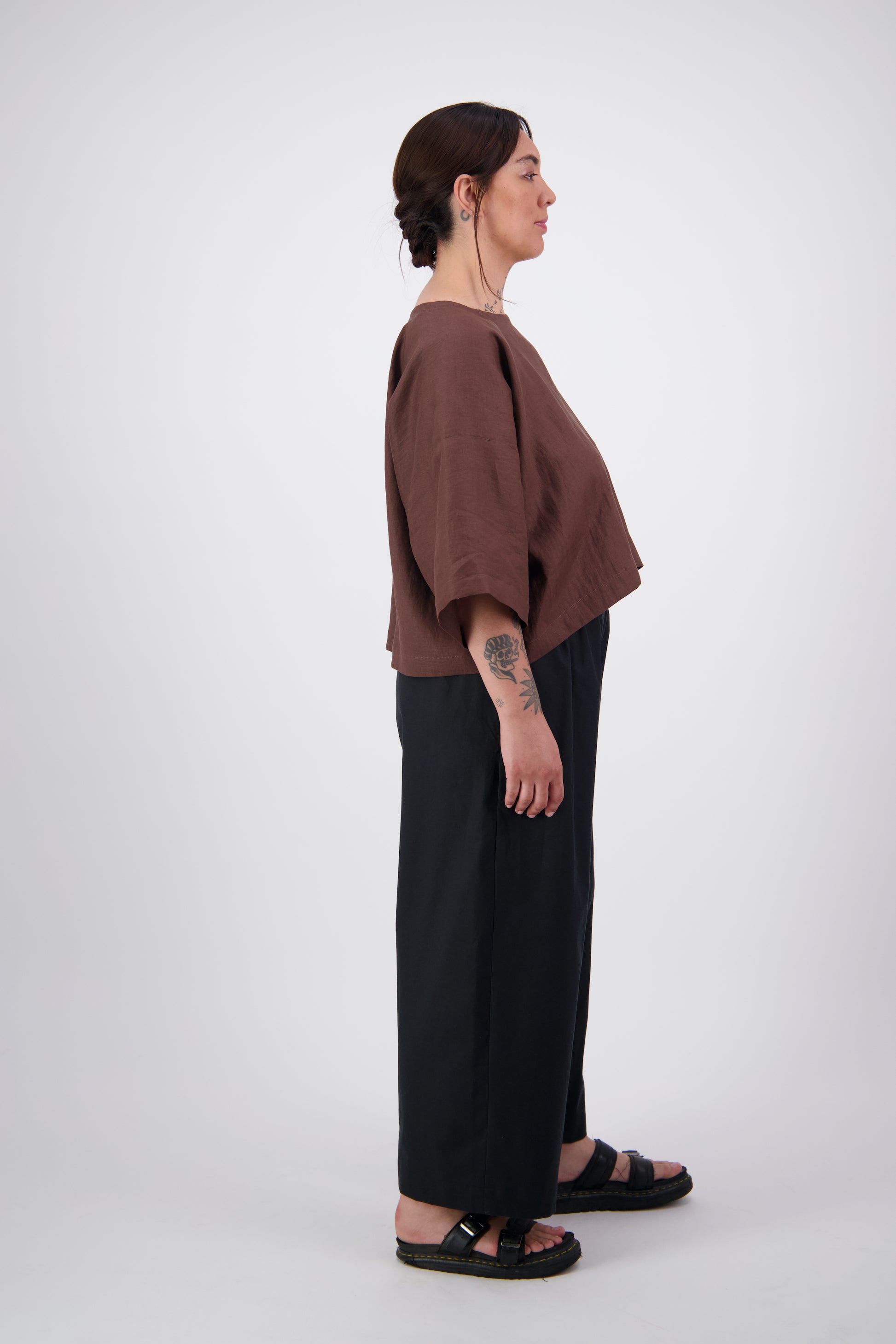 Arlena wearing black twill pants with a brown linen crop tee top