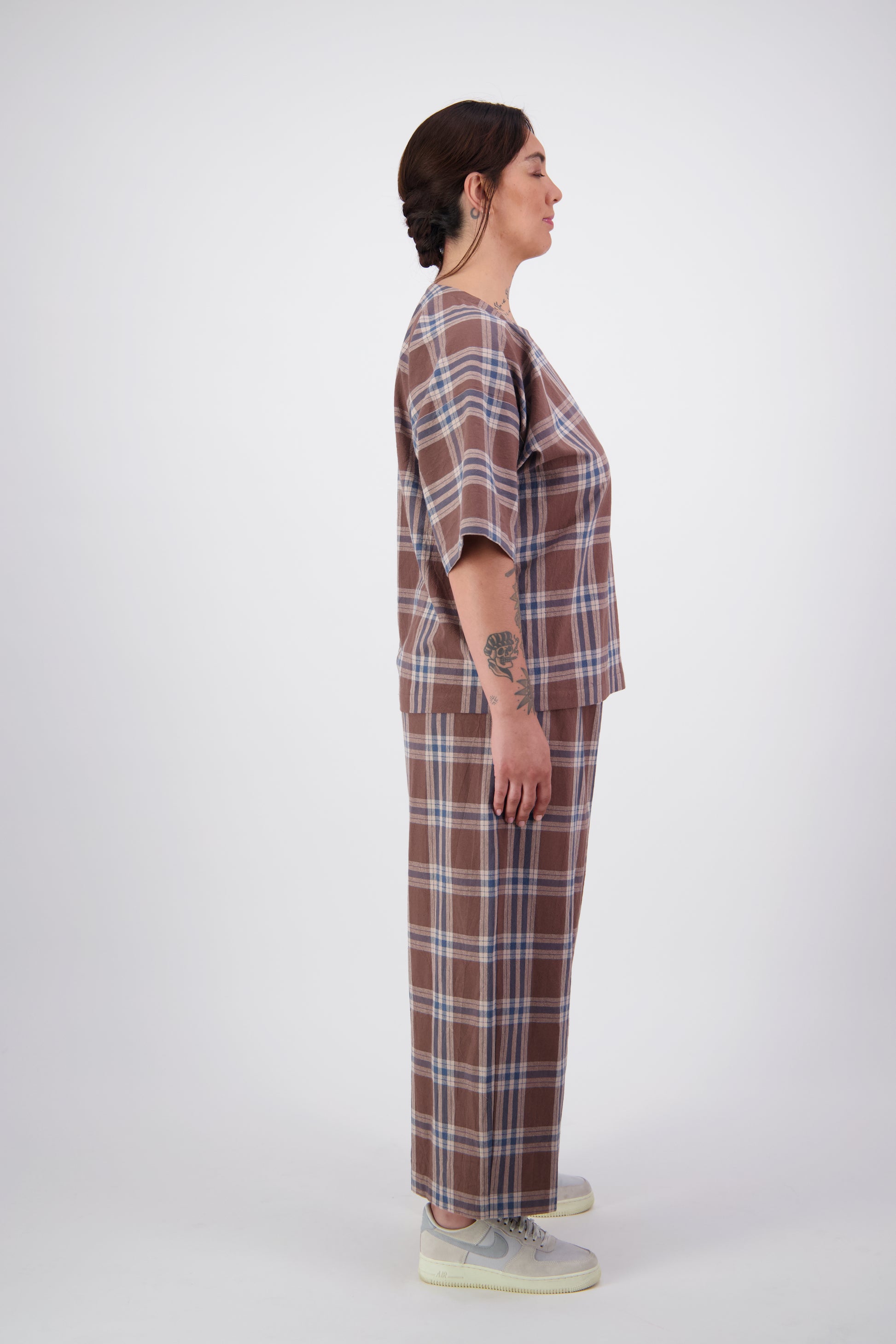 Arlena wearing brown plaid cotton loose fit pants with matching tee top