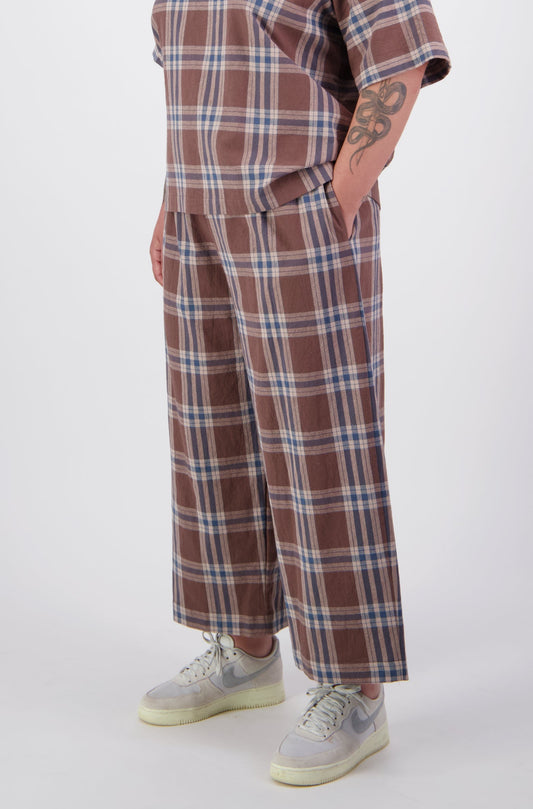 Arlena wearing brown plaid cotton loose fit pants with matching tee top